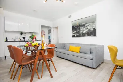 a living room with a table and a couch at Boutique Apartments SoBe in Miami Beach