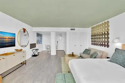 a bedroom with a bed and a living room at Brand New Mondrian - Miami Beach Waterfront Condo in Miami Beach