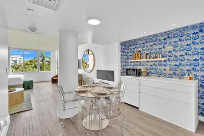 a kitchen and dining room with a table and chairs at Brand New Mondrian - Miami Beach Waterfront Condo in Miami Beach