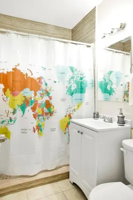a bathroom with a map of the world shower curtain at Mimo 10 - Kitchen - Walkable - Fast WiFi - Free Parking in Miami