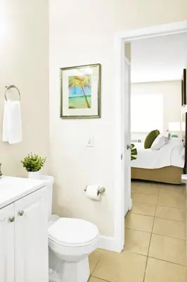 a white bathroom with a toilet and a bed at New Mimo 8 New -Walkable - Smart TV - Nespresso - Free Parking in Miami