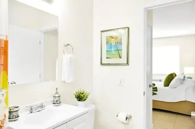 a white bathroom with a sink and a mirror at New Mimo 8 New -Walkable - Smart TV - Nespresso - Free Parking in Miami