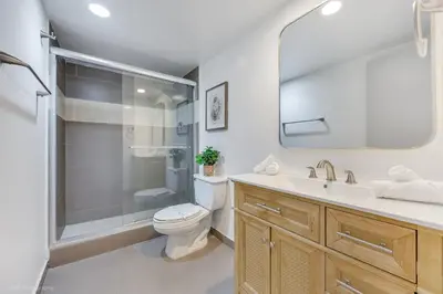 a bathroom with a shower and a toilet and a sink at Beachfront Oasis in Sunny Isles 4BR, Pool & Tennis in Sunny Isles Beach