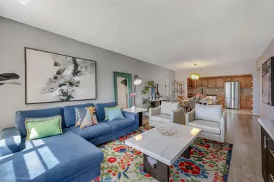 a living room with a blue couch and a table at Beachfront Oasis in Sunny Isles 4BR, Pool & Tennis in Sunny Isles Beach