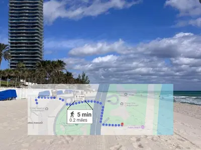 a sign on the beach with a building in the background at Beachfront Oasis in Sunny Isles 4BR, Pool & Tennis in Sunny Isles Beach