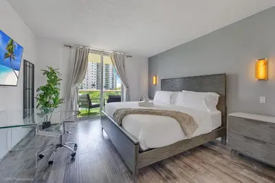 a bedroom with a bed and a glass table at Beachfront Oasis in Sunny Isles 4BR, Pool & Tennis in Sunny Isles Beach