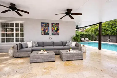 a living room with a couch and a pool at Villa Miami Lakes in Hialeah