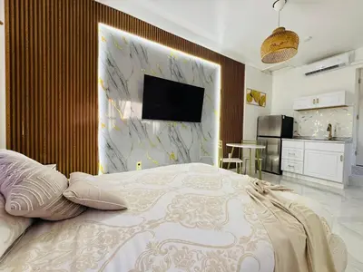 a bedroom with a bed with a tv on a wall at Stylish Studio in Heart of Miami in Miami