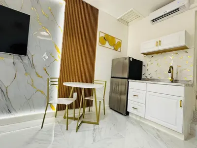 a kitchen with a table and chairs and a refrigerator at Stylish Studio in Heart of Miami in Miami