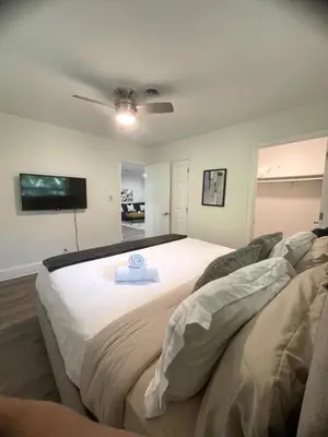 a bedroom with a large bed with a ceiling fan at New Apt 2 Bed 2 Bath with Amazing PATIO in Fort Lauderdale