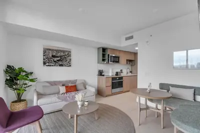 a living room with a couch and two tables at Sunlit 1BR Condo In Downtown Miami in Miami