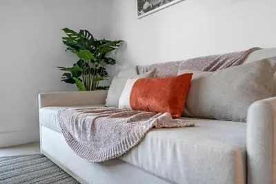 a couch with pillows on it in a living room at Sunlit 1BR Condo In Downtown Miami in Miami