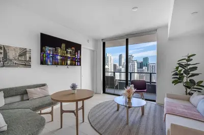 a living room with a couch and a table at Bright and Breezy 1 Bed Unit With Water and City Views in Miami