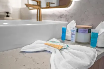 a white towel on a bathroom counter with a sink at Bright and Breezy 1 Bed Unit With Water and City Views in Miami