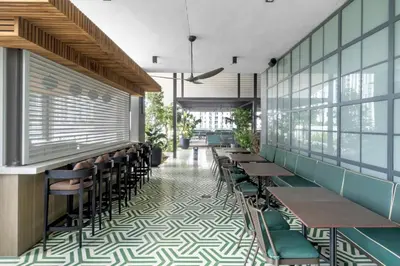 a restaurant with tables and chairs in a room at Experience Miami Vibes in the Heart of Downtown in Miami