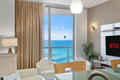 a living room with a view of the ocean at Luxury Top-Level Oasis - Oceanfront Views & Resort Perks in Sunny Isles Beach