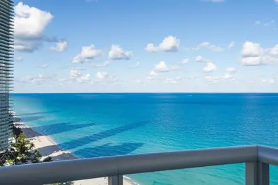 a view of the ocean from the balcony of a condo at Luxury Top-Level Oasis - Oceanfront Views & Resort Perks in Sunny Isles Beach
