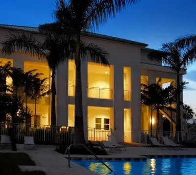 a large building with palm trees and a swimming pool at Provident Doral at The Blue in Miami