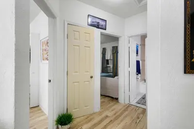 a hallway with a white door and a bedroom at Brickell Stay: Near Beach Downtown Pet-Friendly in Miami
