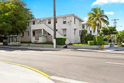 an empty street in front of a white building at Brickell Stay: Near Beach Downtown Pet-Friendly in Miami