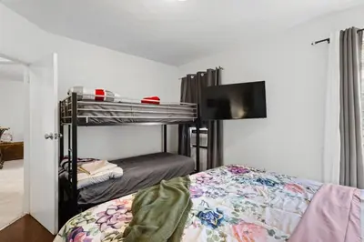 a bedroom with two bunk beds and a flat screen tv at Little Havana 2BR – Near Brickell Midtown in Miami