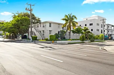 an empty street with palm trees and buildings at Little Havana 2BR – Near Brickell Midtown in Miami