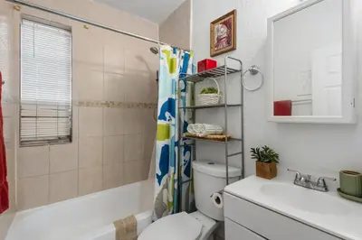 a bathroom with a toilet and a sink and a shower at Little Havana 2BR – Near Brickell Midtown in Miami