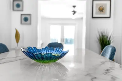 a blue glass bowl sitting on top of a table at Stunning Tropical Pool House Miami Coconut Grove in Miami