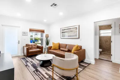 a living room with a couch and a table at Stunning Tropical Pool House Miami Coconut Grove in Miami