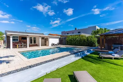 a swimming pool in the backyard of a house at Stunning Tropical Pool House Miami Coconut Grove in Miami