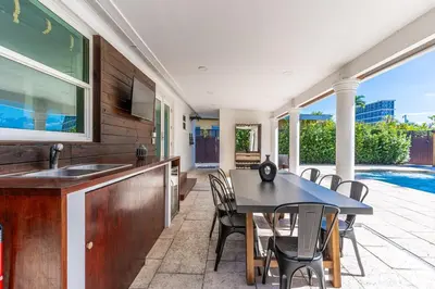 a kitchen and dining room with a table and chairs at Stunning Tropical Pool House Miami Coconut Grove in Miami