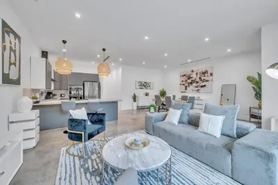 a living room with a couch and a table at Wonderful New Tropical Pool House North Miami in Gold Coast Heliport