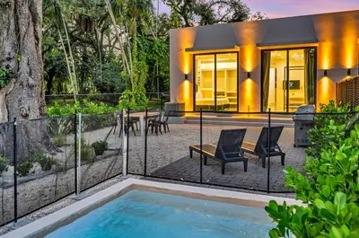a house with a swimming pool in the backyard at Wonderful New Tropical Pool House North Miami in Gold Coast Heliport
