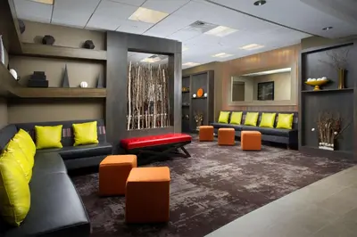a lobby with couches and orange and yellow pillows at Homewood Suites by Hilton Miami Downtown/Brickell in Miami