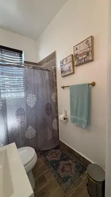 a bathroom with a shower curtain and a toilet at Noemi's Studio Suite Steps To Marlins Stadium At Little Havana in Miami
