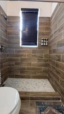a bathroom with a tub with a toilet and a window at Noemi's Studio Suite Steps To Marlins Stadium At Little Havana in Miami
