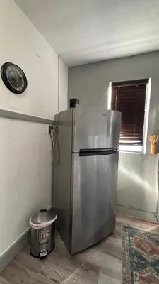 a kitchen with a stainless steel refrigerator in a room at Noemi's Studio Suite Steps To Marlins Stadium At Little Havana in Miami