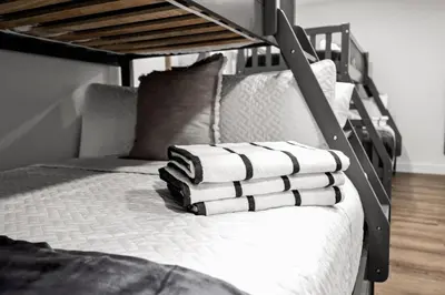 a bunk bed with towels on top of it at Modern & Cozy Private Pool Home in Parkway Regional Medical Center Heliport