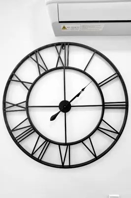 a black and white clock hanging on a wall at Modern & Cozy Private Pool Home in Parkway Regional Medical Center Heliport