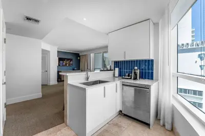 a white kitchen with a sink and a window at FontaineBleau Suite at Miami Beach in Miami Beach