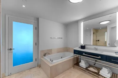 a bathroom with a tub and a large mirror at FontaineBleau Suite at Miami Beach in Miami Beach