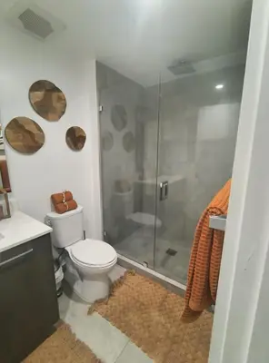 a bathroom with a toilet and a glass shower at Miami-Brickell Luxury 2BR-2BATH with skyline VIEWS - walking distance to KASEYA-HEAT ARENA & BAYSIDE - Port of MIAMI cruise ships in Miami
