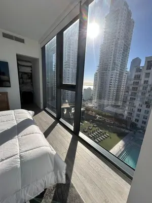 a bedroom with a large window with a view of a city at Miami-Brickell Luxury 2BR-2BATH with skyline VIEWS - walking distance to KASEYA-HEAT ARENA & BAYSIDE - Port of MIAMI cruise ships in Miami