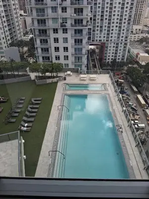 a large swimming pool on top of a building at Miami-Brickell Luxury 2BR-2BATH with skyline VIEWS - walking distance to KASEYA-HEAT ARENA & BAYSIDE - Port of MIAMI cruise ships in Miami