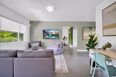 a living room with a purple couch and chairs at 175 Casa Buena Blanca in Miami