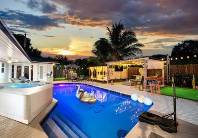 a swimming pool in the backyard of a house at Top Villa Near Beach with Game Room, Hot Tub and Pool in Pembroke Pines