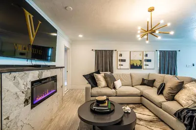 a living room with a couch and a tv at Top Villa Near Beach with Game Room, Hot Tub and Pool in Pembroke Pines