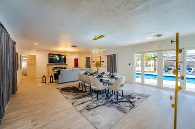 a dining room and living room with a table and chairs at Top Villa Near Beach with Game Room, Hot Tub and Pool in Pembroke Pines