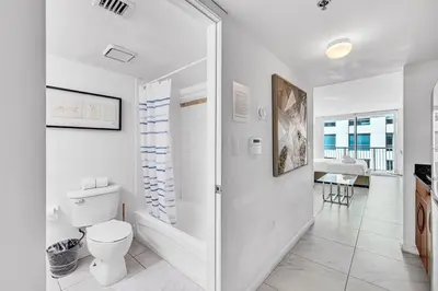 a bathroom with a toilet and a walk in shower at Central Unit in Heart of Brickell in Miami