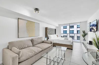 a living room with a couch and a bed at Central Unit in Heart of Brickell in Miami